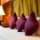 Purple pillows on bed.