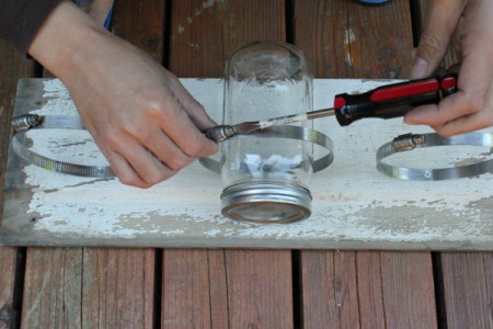 Placing the canning jars in the clamps.