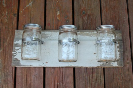 Clamps with canning jars in them.