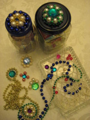 Two jars with finished lids, motifs, and beads.