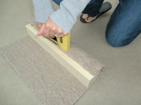 Attaching carpet to post.