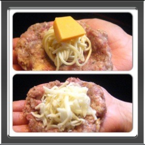 Placing spaghetti ball on patty and adding cheese.