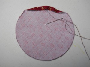 Beginning to sew the running stitch around the circle.