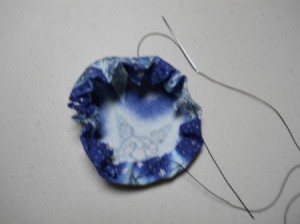 Fabric removed from maker and beginning to pull up gathers.