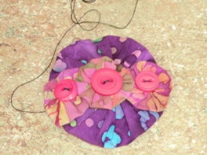 Sewing on last yo yo, step 4.