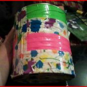 Can covered with floral and bright pink and green duct tape.