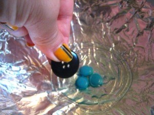 Begin gluing buttons.
