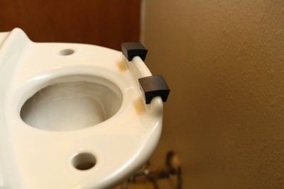Place Rubber Spacers on Back of New Toilet