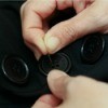 Closeup of Sewing Buttons On Clothing