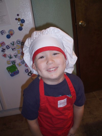 A child chef after making tomato sauce