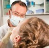 Dentist Examining Woman's Teeth