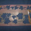 A leaf stencil attached to a wall.