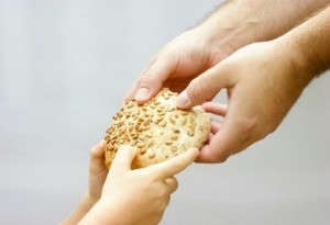 Giving bread to the needy.
