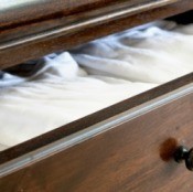 Shirts folded neatly in a dresser drawer.