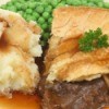 Plate of food covered in gravy.