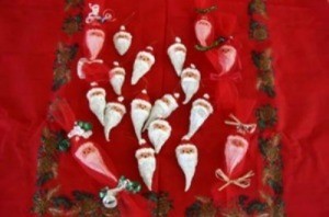 Milkweed pods painted like Santa.