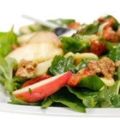 A healthy salad with light dressing on it.