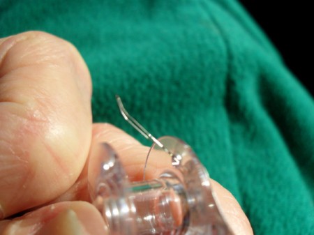 Putting thread puller through bobbin hole.