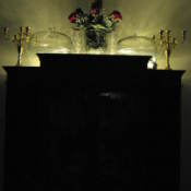 Lights on top of cabinet, reflecting off wall.