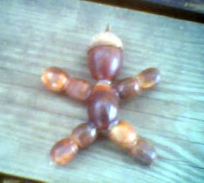 Man shaped decoration made from acorns.
