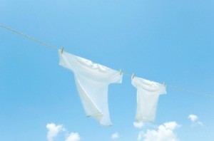 White t-shirts hanging on a clothesline.