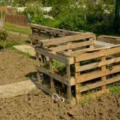 Compost pile made with wood pallets.
