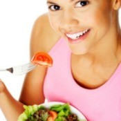 A woman eating a salad.