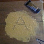 Letter A in puddle of makeup.