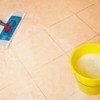 Someone mopping a floor.