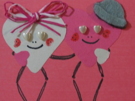 Closeup of finished heart stick people.