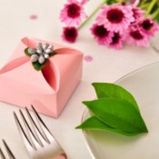 A gift for a wedding guest.  A small pink box with a gift in it.