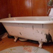Clawfoot tub with peeling paint.