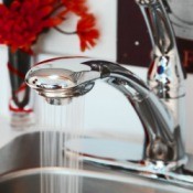 Faucet running in a kitchen that uses well water.