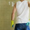 Man Cleaning Shower Tiles