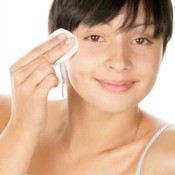 A woman treating a blemish.