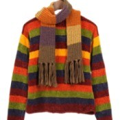 Colorful sweater hanging in a closet.