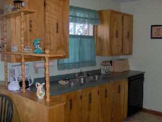 View of kitchen sink and surrounding cupboards