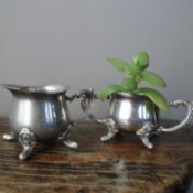 Photo of Silver Creamers on a Table