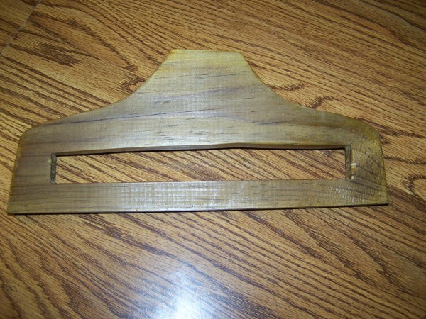 Slotted hanger lying on wood surface