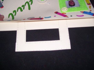 The square cut handle of the briefcase.