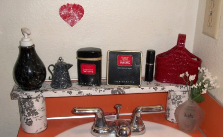 A makeshift shelf for the bathroom counter, covered in contact paper.