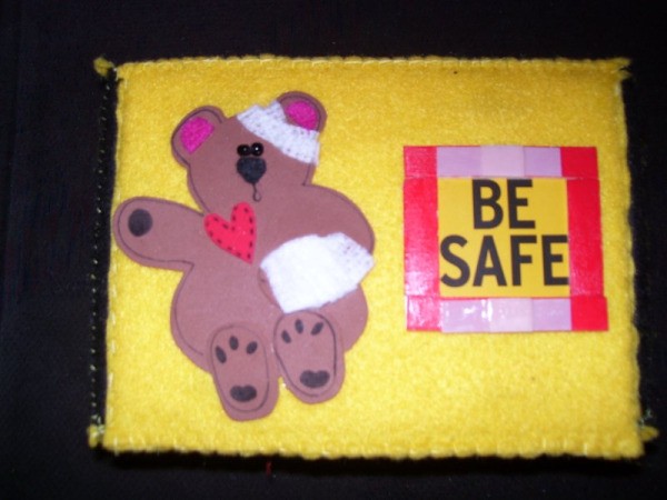 A felt covered box with a "boo boo bear" on the cover.