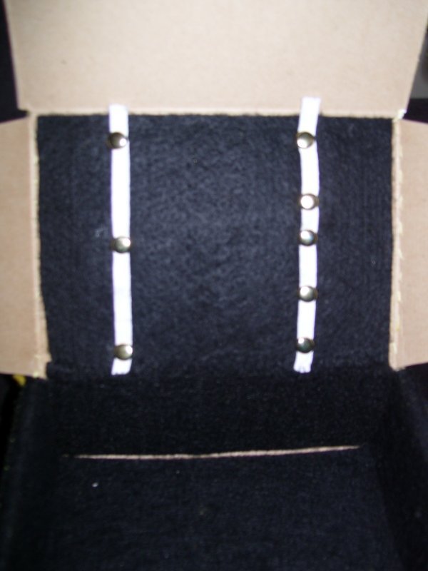 Attaching elastic to the box to hold items.