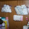 Use plastic baggies to store small items on a bathroom wall.