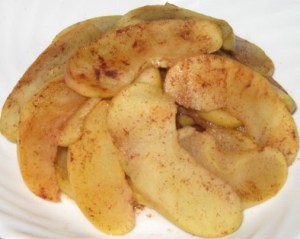 Slices of apple cooked in the microwavea and sprinkled with cinnamon.