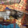 A white ferret and a brown ferret in a cage.
