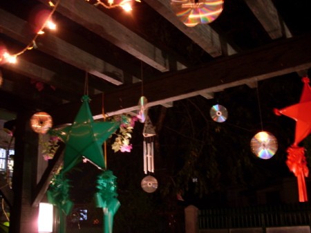 Decorative CDs hanging over a outdoor deck.