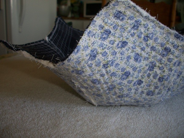 A blue version of a fabric bowl, with denim inside and a blue flowered fabric outside.
