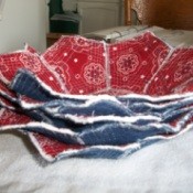 A stack of fabric flower bowls in blue and red.