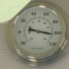 A round thermometer showing temperatures over 100 degrees F.